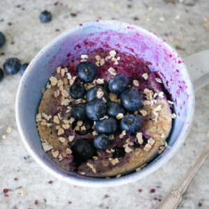 The Mug Cake topped with blueberries and oats.