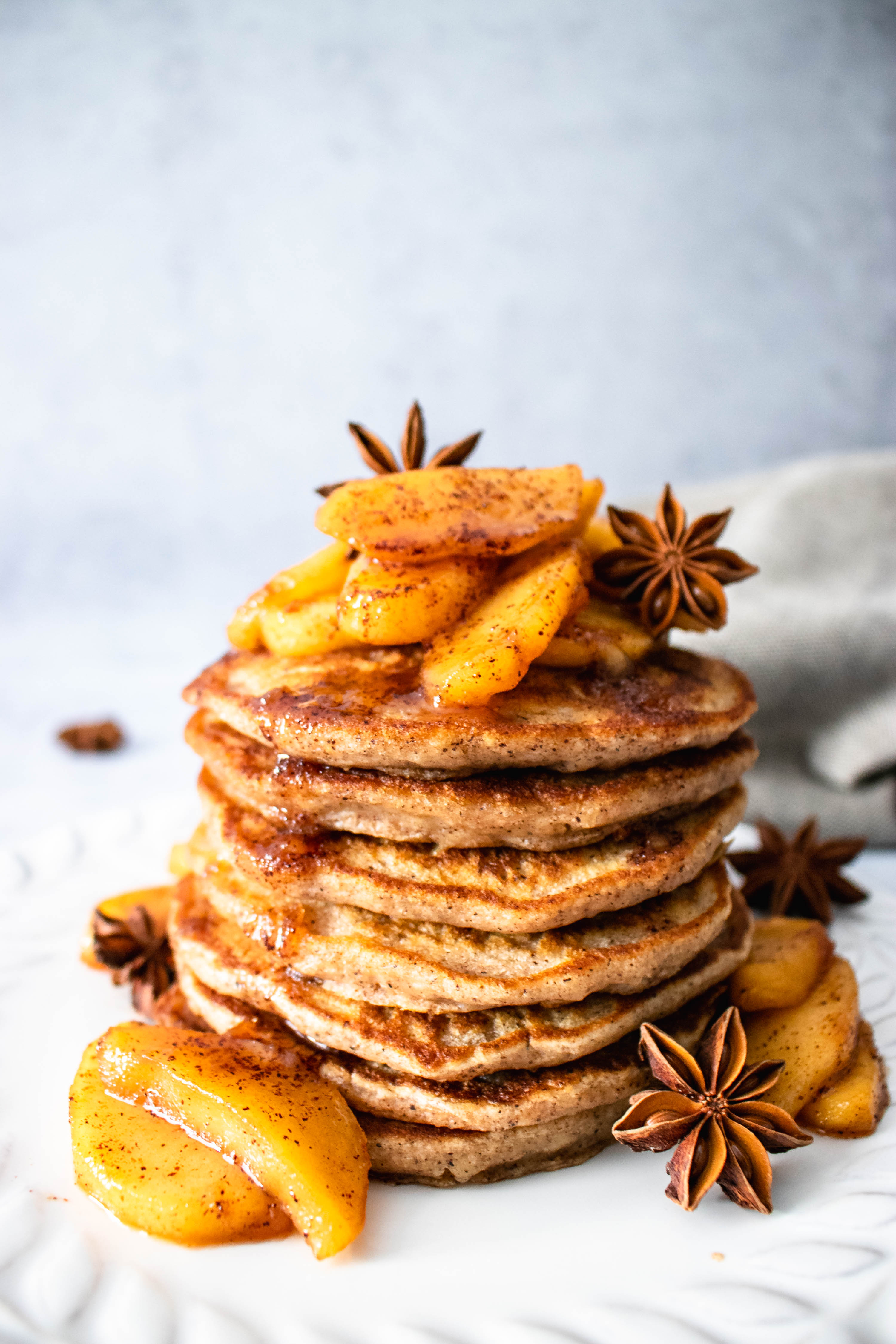 Vegan Apple Pancakes topped off with warm apples and a sprinkle of cinnamon.