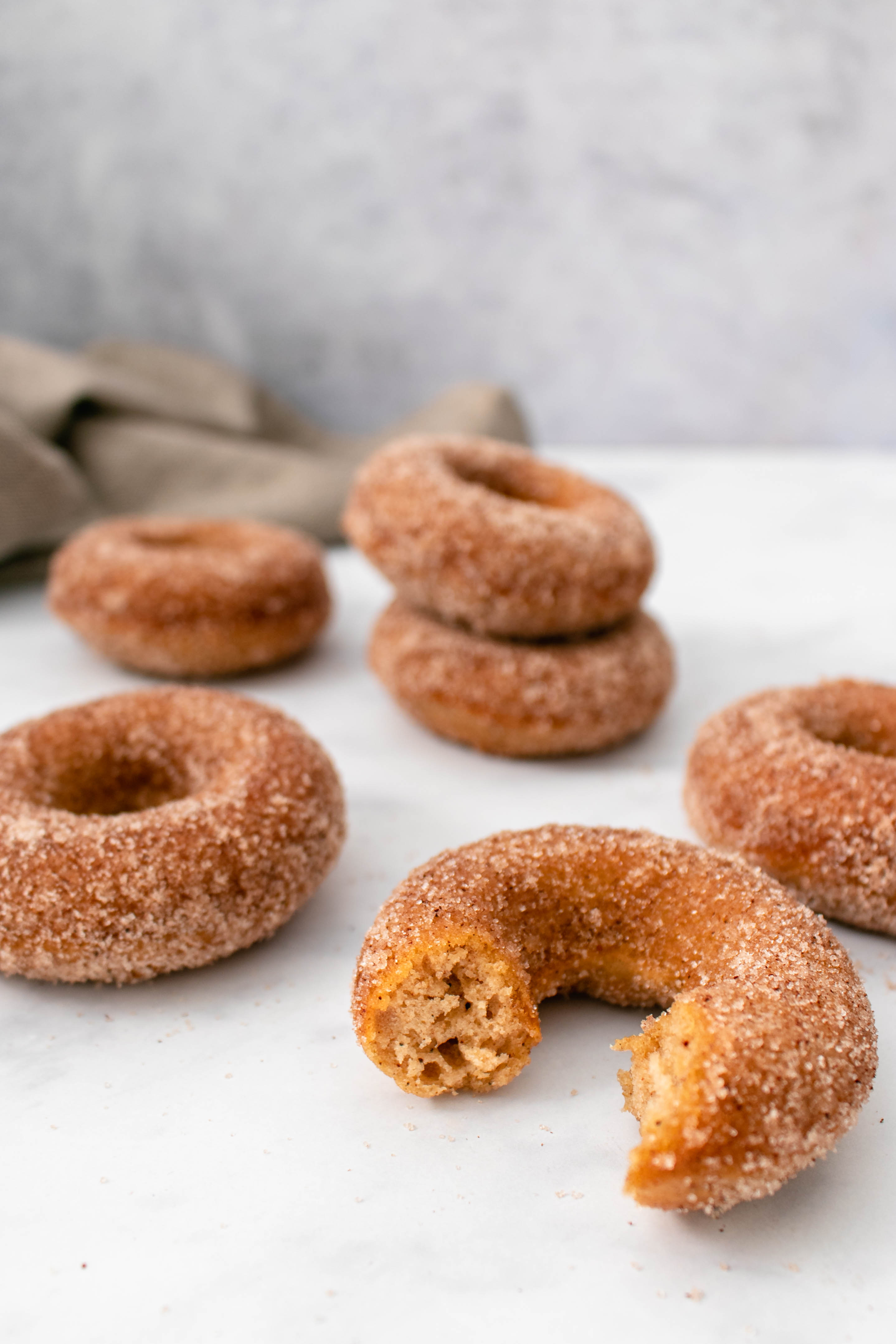 baked chai donuts with a bite taking out of one