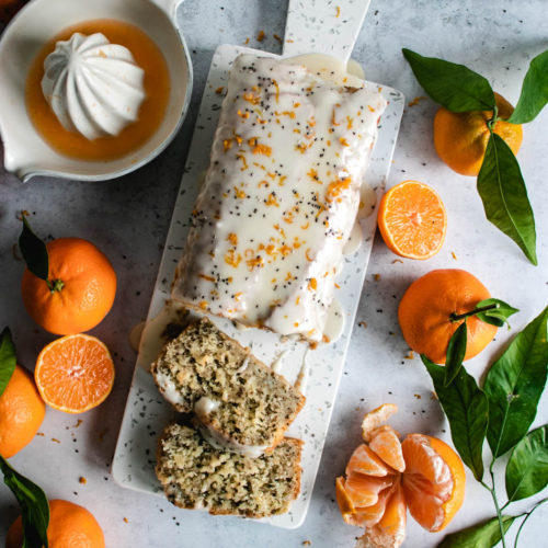 Vegan Clementine Cake with a glaze and fresh clementines.