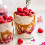 two jars of Peanut butter and jelly overnight oats topped with raspberries