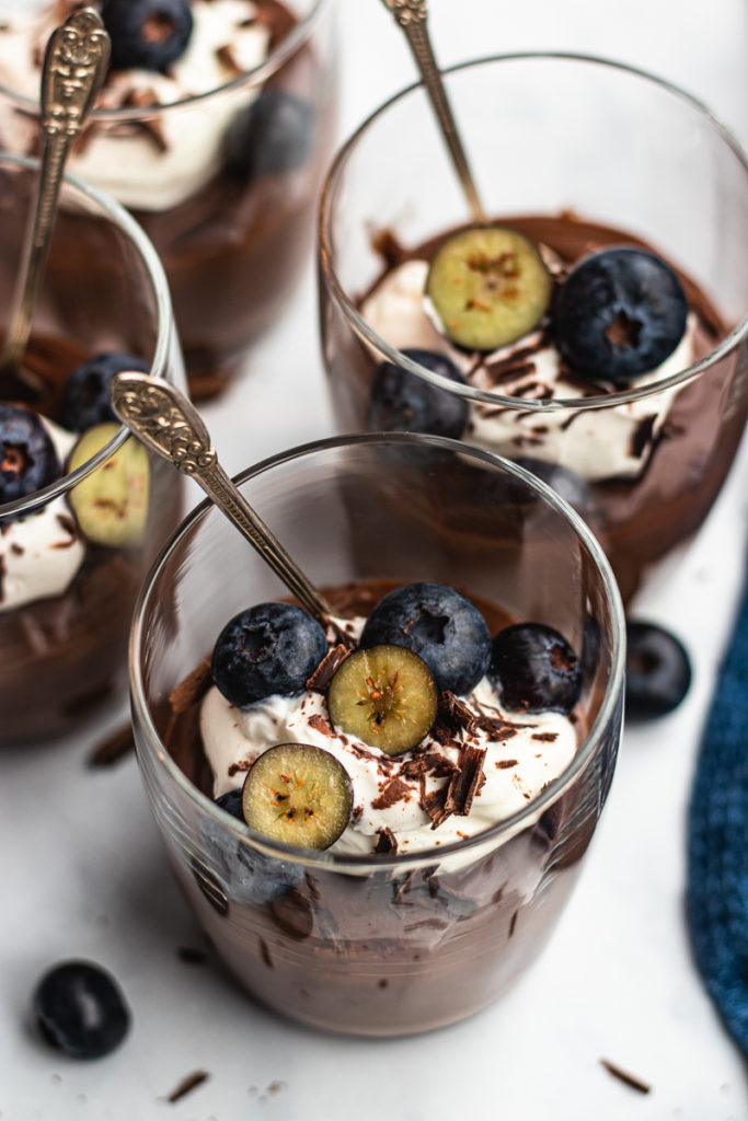 Chocolate pudding with cram and blueberries