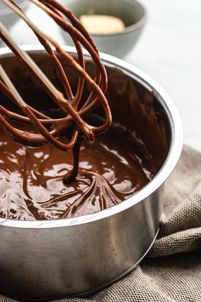 closeup of whisk in smooth chocolate pudding
