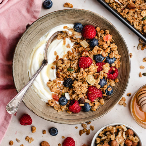 Crunchy and healthy air fryer granola served with yoghurt and fresh berries