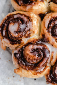 The cinnamon rolls topped with frosting.