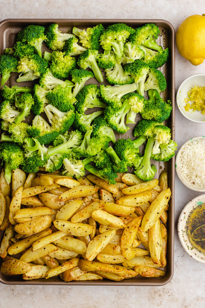 The roasted potatoes on one side of the baking tray, and the broccoli on the other.