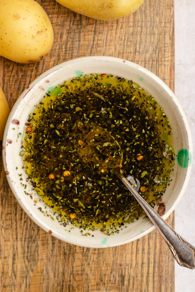 The olive oil and spices mixed in a small bowl.