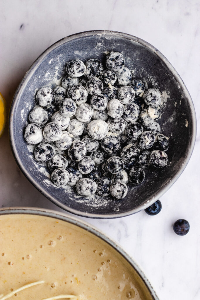 Step 4, tossing the blueberries in flour.