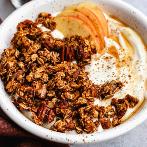 Apple Pie Granola served in a bowl with greek yoghurt.