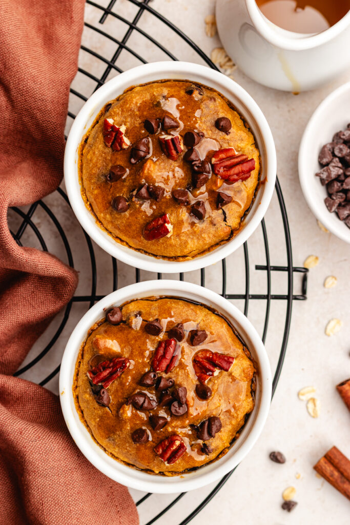 The Pumpkin spice baked oats in ramekins topped with nuts and chocolate chips.