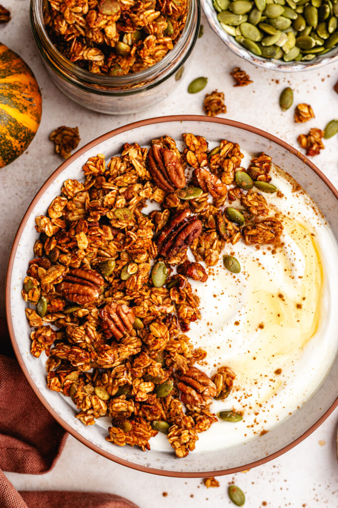 Pumpkin spice granola served in a bowl with some yoghurt.