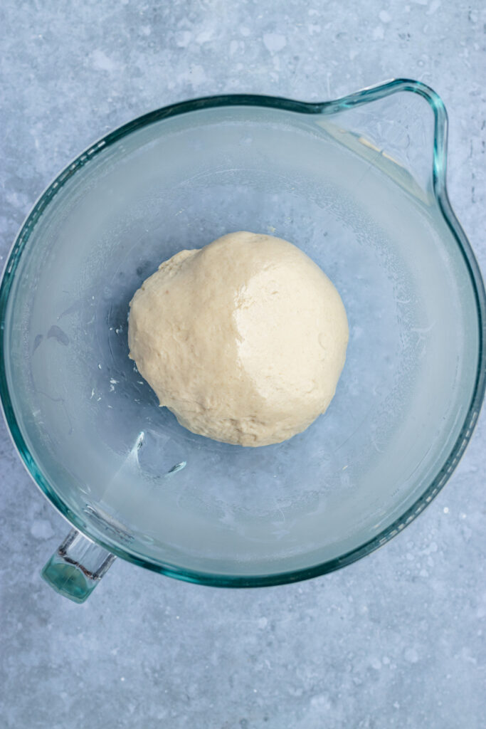 The dough in a glass bowl before rising.