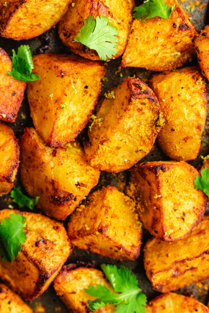 Close up of these Curry roasted potatoes topped with cilantro.