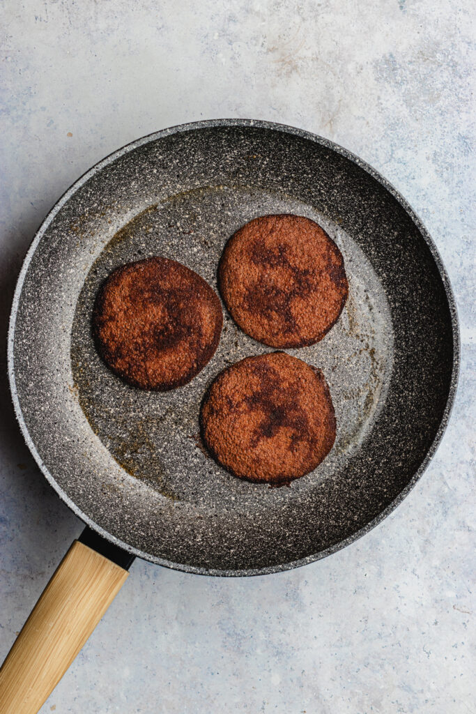 The cooked pancakes in the frying pan. 