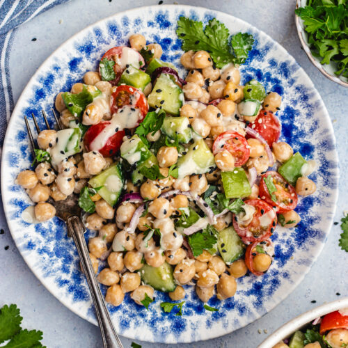 Chickpea tahini salad on a plate with a fork.