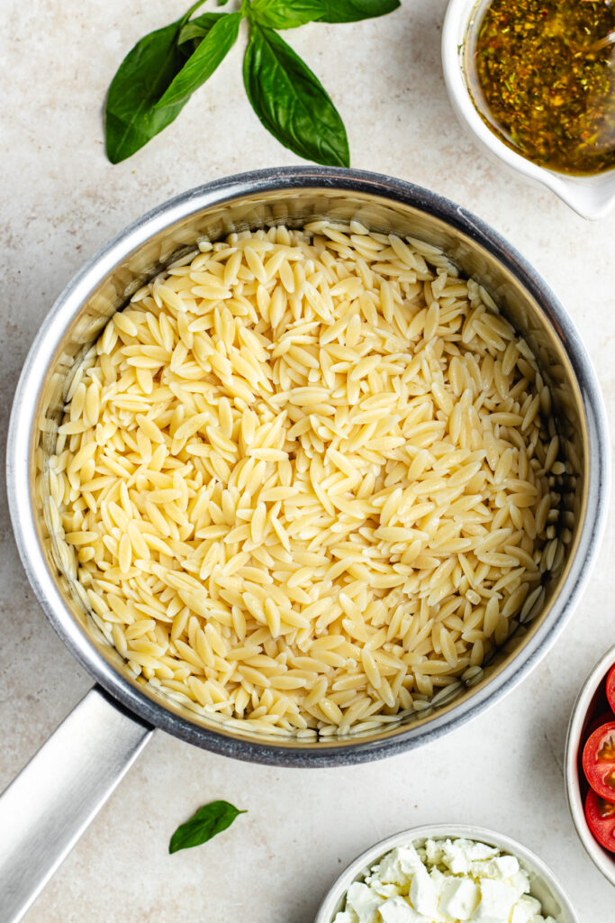 The cooked orzo in a sauce pan.