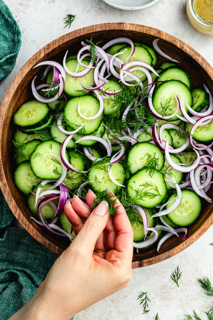 Adding the dill to the bowl.
