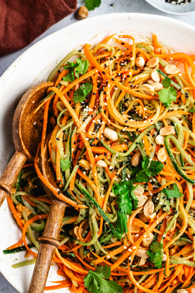 The salad in a salad bowl topped with chopped peanuts and coriander.