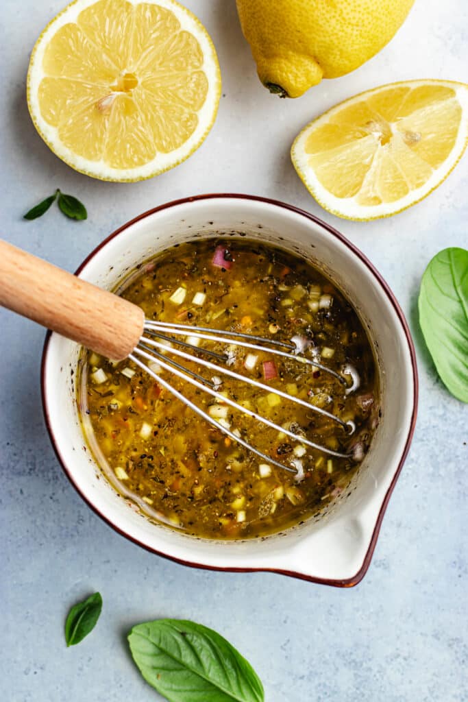 The salad dressing in a small bowl.