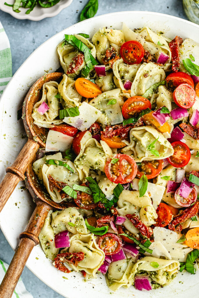 The tossed tortellini salad in a large bowl. 