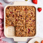 The baked oats cut into pieces, and one pice served on a small plate.