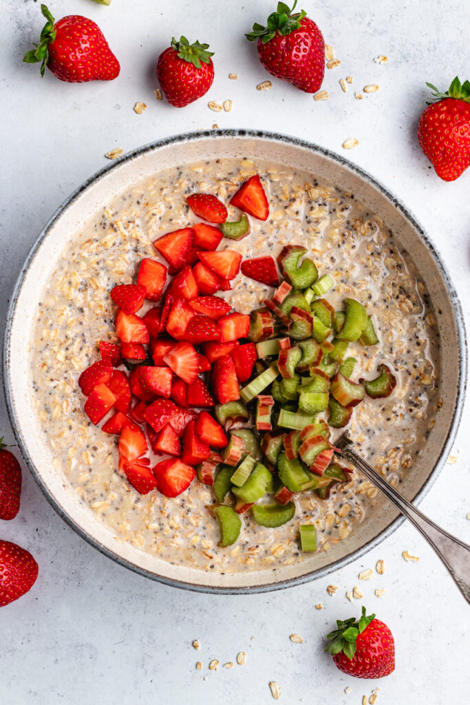 The added chopped strawberries and rhubarb in the mixing bowl.