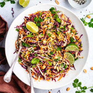 The salad in a big bowl topped with peanuts and fresh cilantro.