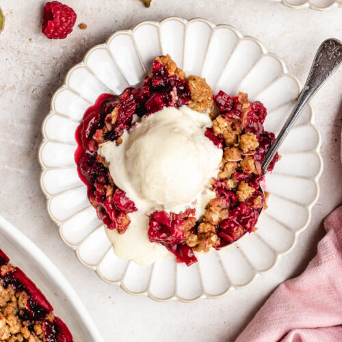 The crisp on small plates topped with vanilla ice cream.