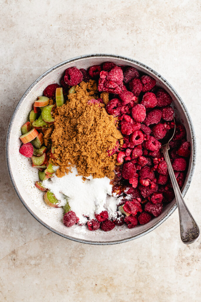 The raspberries, rhubarb, sugar and cornstarch in a mixing bowl.
