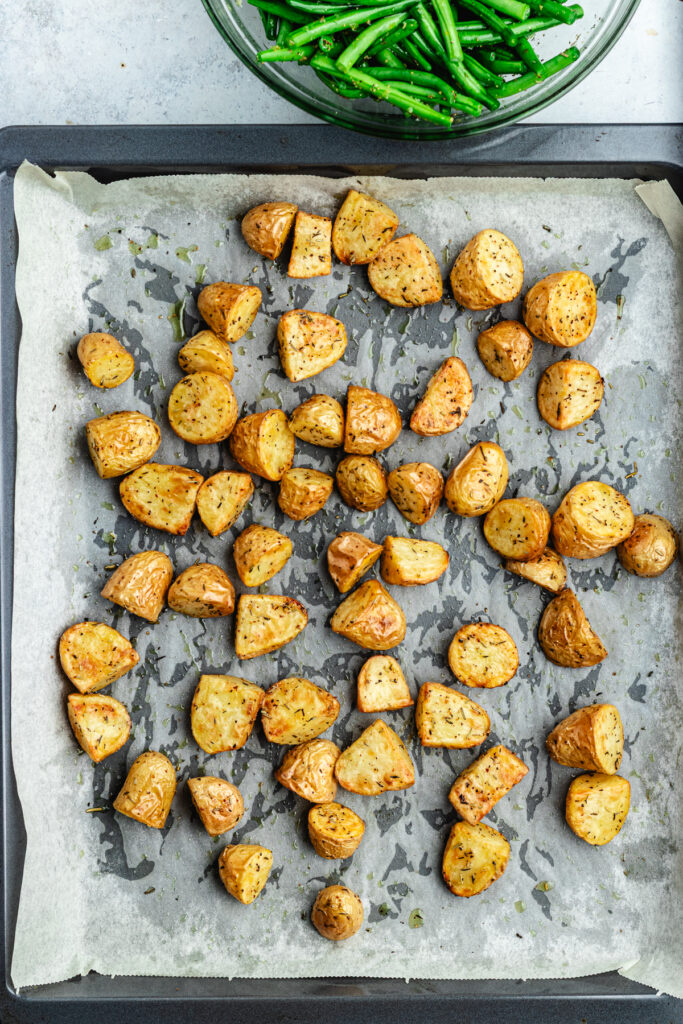 The roasted potatoes on the baking sheet.