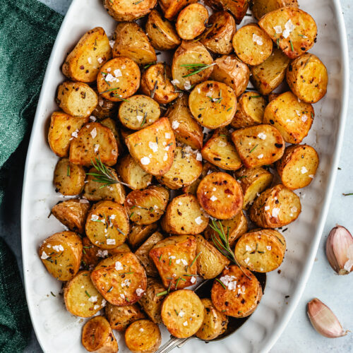 The roasted potatoes on a serving platter.