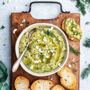 The dip in a bowl with bread slices.
