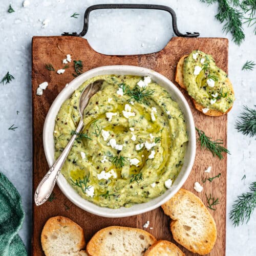 The dip in a bowl with bread slices.