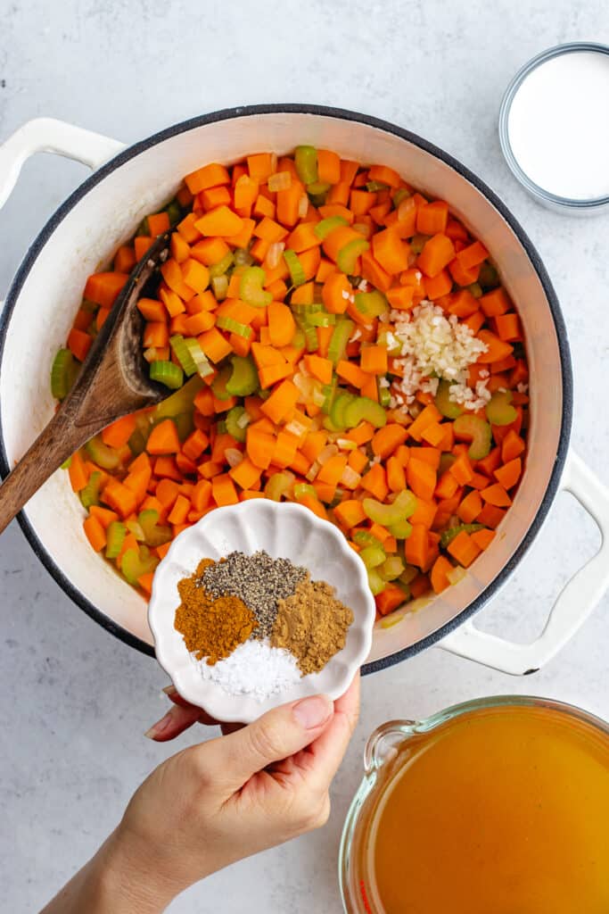 Adding the spices to the pot.
