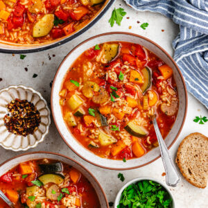The soup in two bowls and in the pot, topped with chopped parsley.