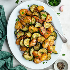The roasted veggies on a serving platter topped with chopped parsley.