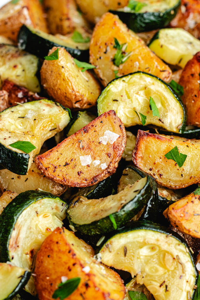 The roasted veggies on a serving platter topped with chopped parsley.