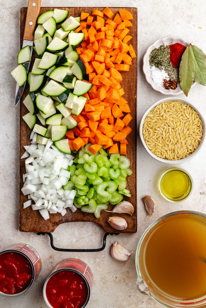 The chopped veggies on a cutting board and the rest of the ingredients in small bowls.