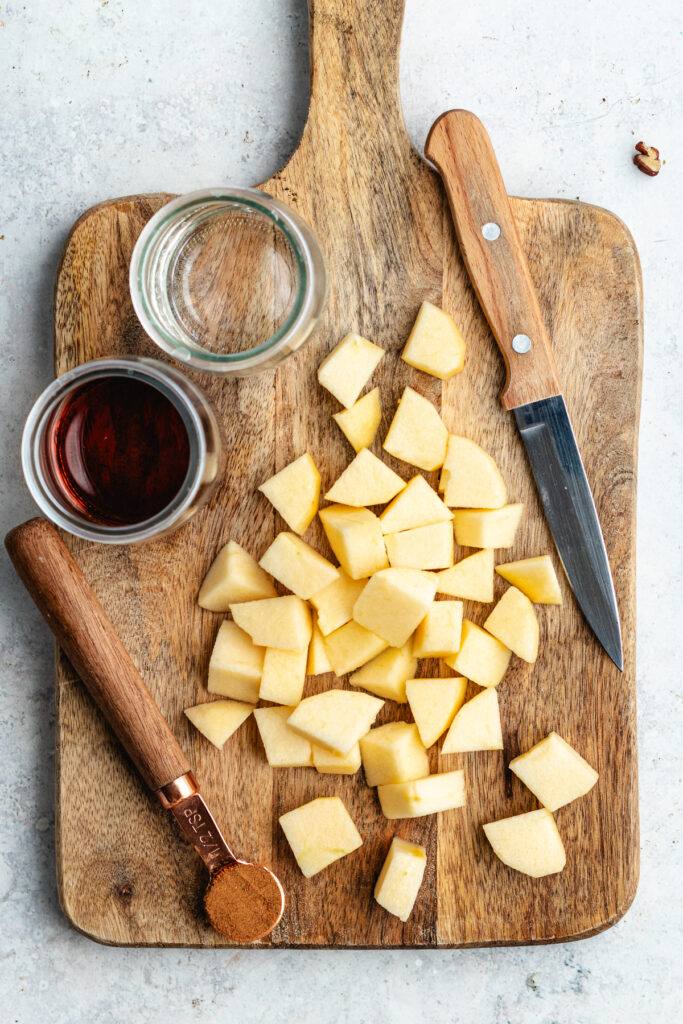 The chopped apples on the cutting board.