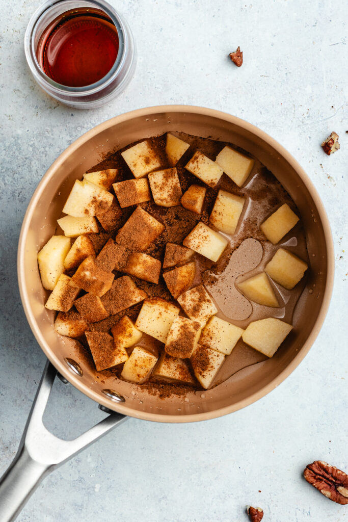 The apples, water and cinnamon in a small sauce pan.