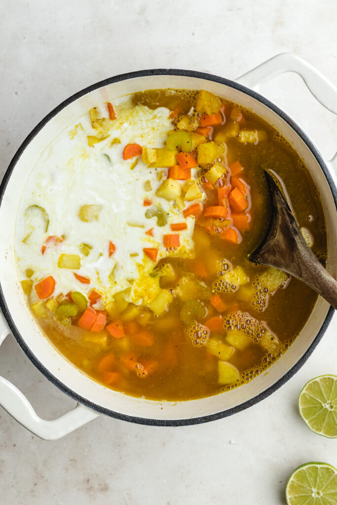 The added coconut milk and vegetable broth to the pot.