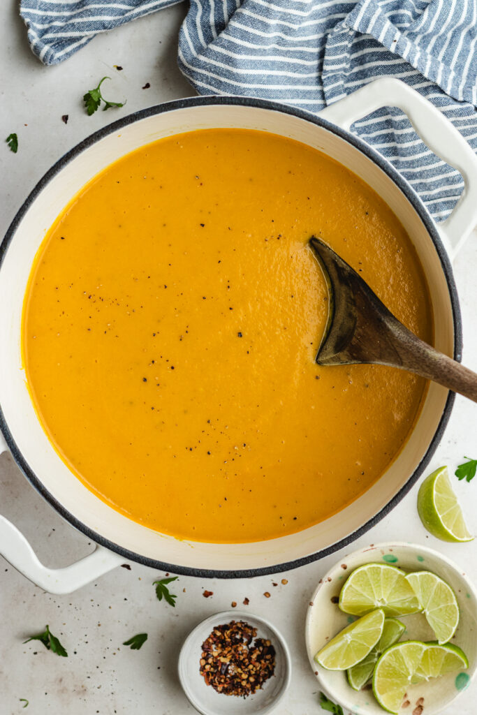 The finished soup ion the pot with a spoon.