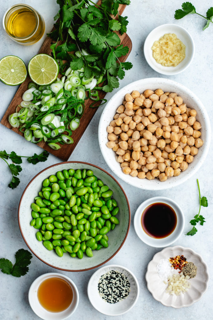The ingredients for the salad in small bowls and a cutting board.