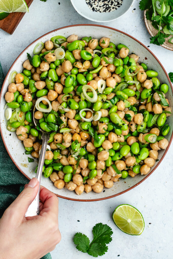 Stirring together the salad with a spoon.