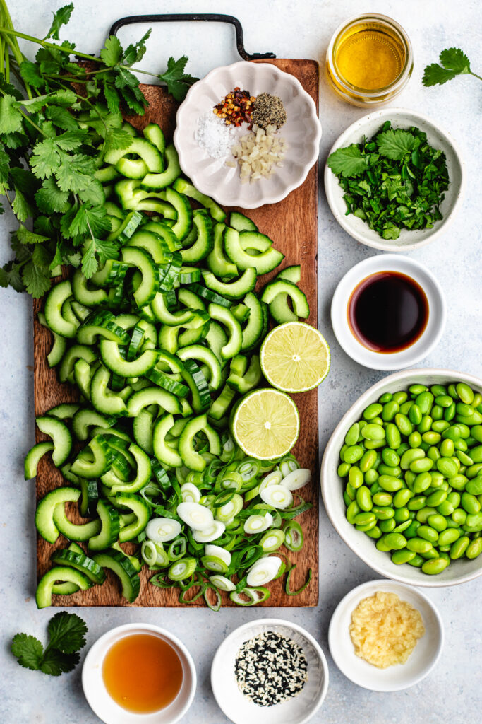 The salad ingredients on a cutting boars and in small bowls.