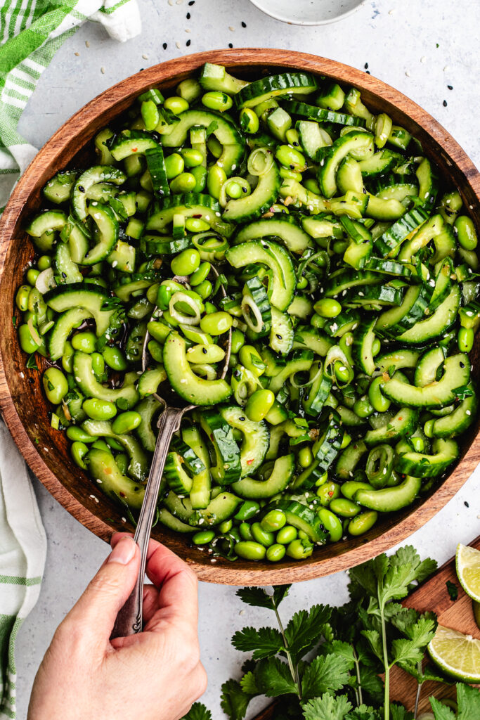Stirring together the salad with the dressing.