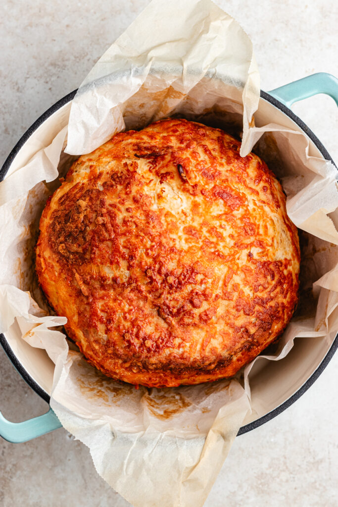 The baked bread in the dutch oven.