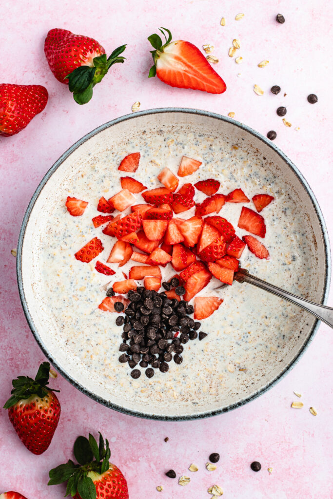 The added chopped strawberries and chocolate chips to the bowl.