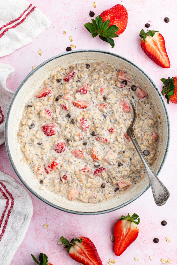 The overnight oats in a bowl with a spoon.