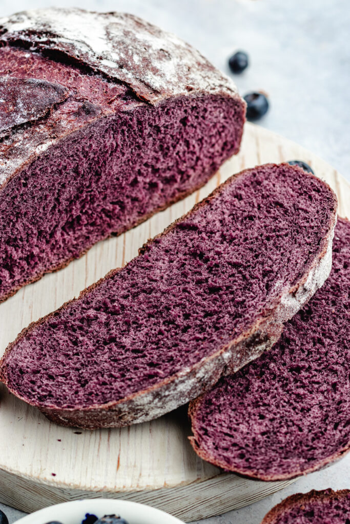 The bread on a cutting board, cut into slices.